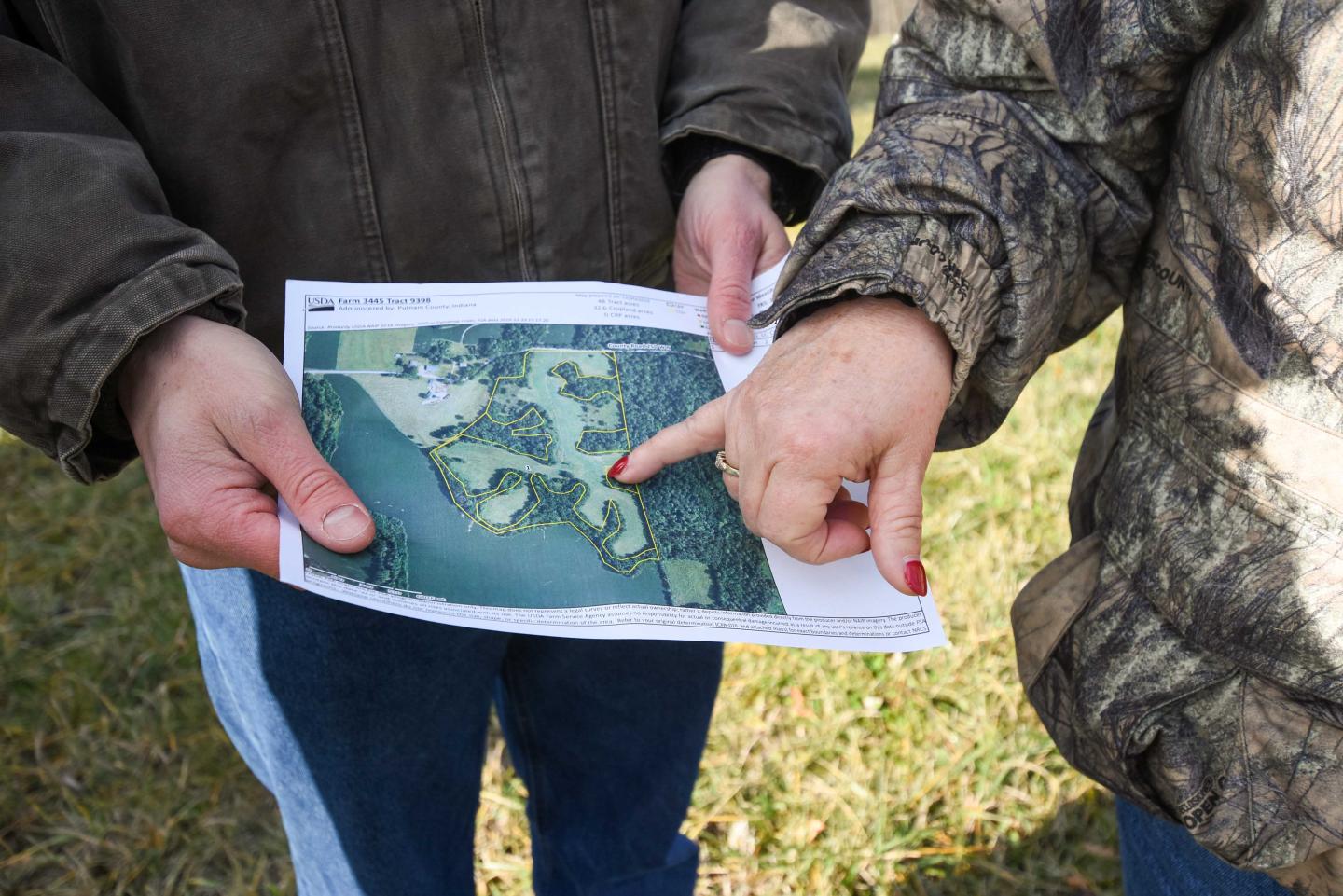 Peggy Royer, who co-owns Wagoner Christmas Tree Farm in Putnam County, Indiana, talks through an EQIP proposal for their farm with Indiana NRCS District Conservationist Thomas Perkins Dec. 14, 2020. 