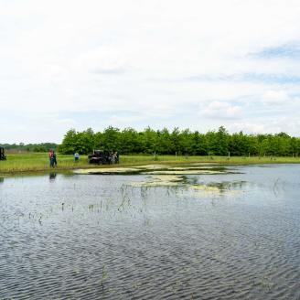 Indiana NRCS staff and Mark Magura, the owner of Leap Frog LLC in Starke County, Indiana, tour a macro currently filled with water May 25, 2021 that was created as part of the wetland restoration on his property after it was enrolled in the NRCS' Wetland Reserve Easement Program.