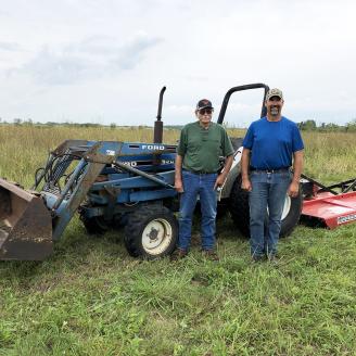 Two men in wildlife habitat-friendly land in Fayette County, Iowa
