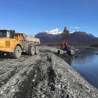 Construction equipment helps repair a levee in Valdez, Alaska