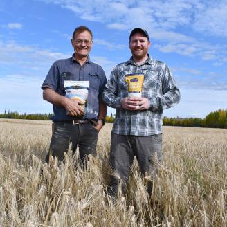 Two men standing in a field of barley