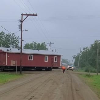 A home is moved across a road