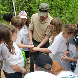 Chris Hunter showing specimens found in creek