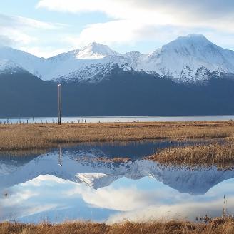 Water and mountains in Alaska with a reflection of the mountains on the water