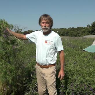 Woodstown District Conservationist Mona Peterson talks with organic producer Bob Muth on his farm in Williamstown, NJ.
