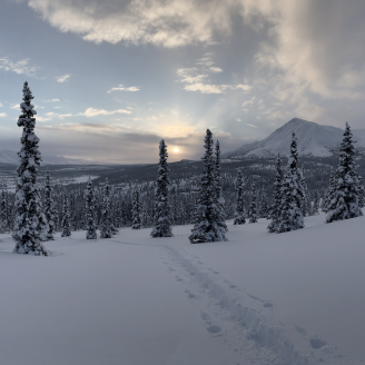 Snow covered landscape at sunset