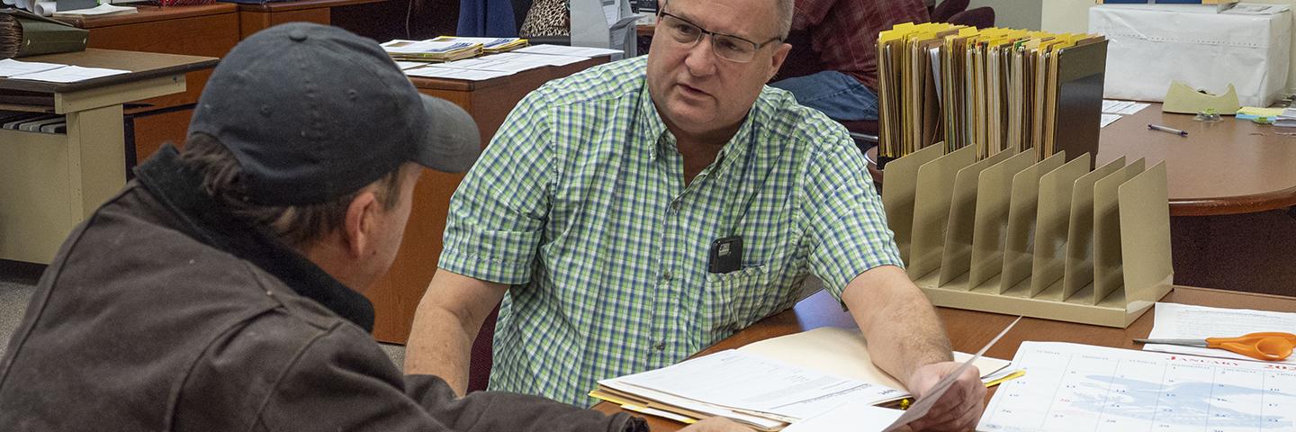 An NRCS team member works with a producer to apply for assistance.