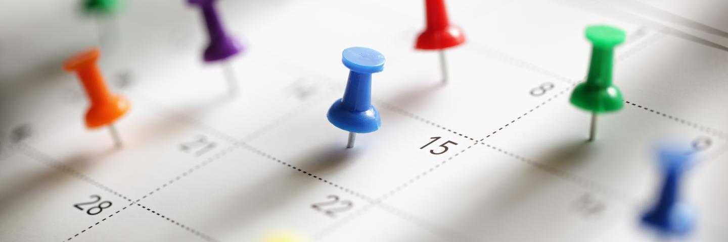 Pins on a calendar.