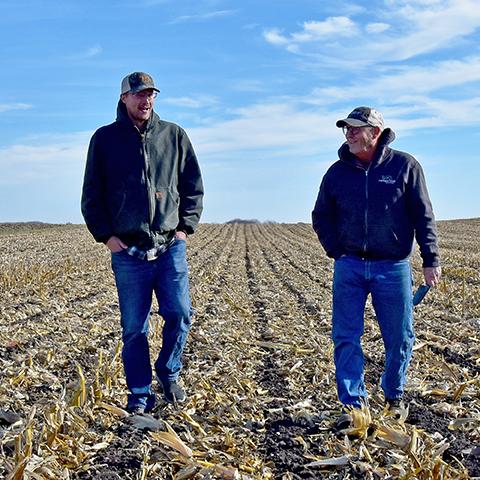 Josiah Olson with NRCS talks to Mark Kingland of Winnebago County, Iowa, about his strip-till management on his corn-soybean acres.