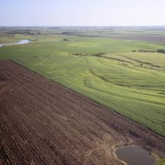 Aerial photo of a tilled field and grassland