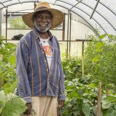 A farmer and an NRCS employee in a seasonal high tunnel