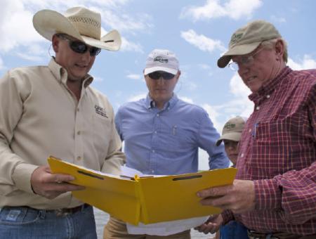 NRCS Employees in the field with producers