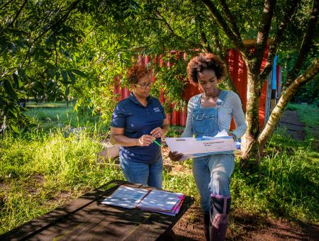 District Conservationist reviewing conservation plan and contracts with urban farmer