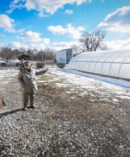 Aster Bekele, the founder of The Felege Hiywot Center in Indianapolis, Indiana, gives Jerod Chew, Indiana NRCS district conservationist, a tour of the center's high tunnel that was built in November 2020. The high tunnel was funded in part through the NRCS's Environmental Quality Incentives Program. (Indiana NRCS photo by Brandon O'Connor)